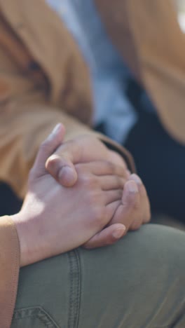 Vertical-Video-Close-Up-Shot-Of-Loving-Muslim-Couple-On-Date-Sitting-And-Holding-Hands